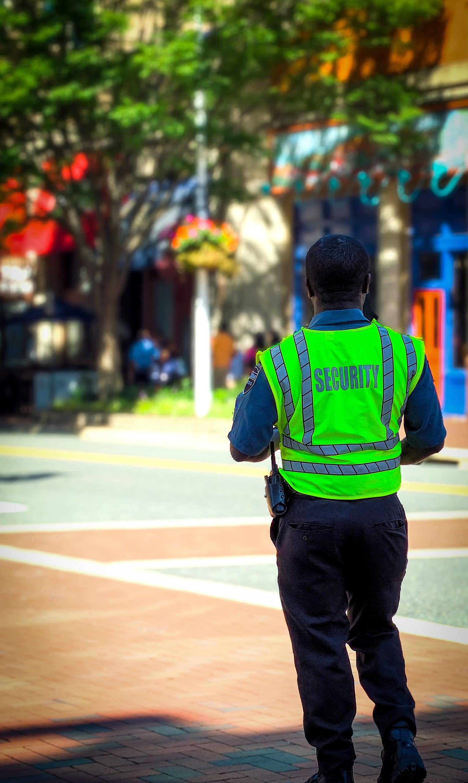 personne de dos dans la rue portant un gilet sécurité